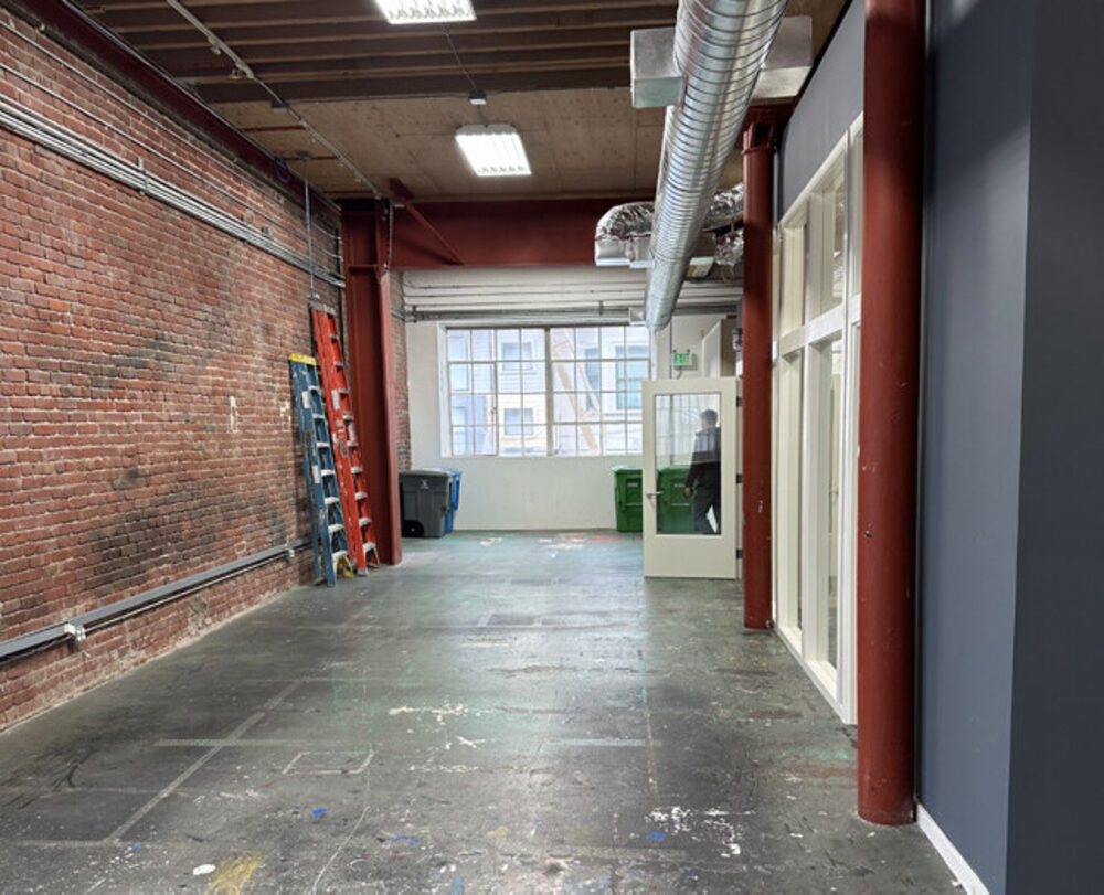 1261-1263 Howard Street brick-walled floor with large windows