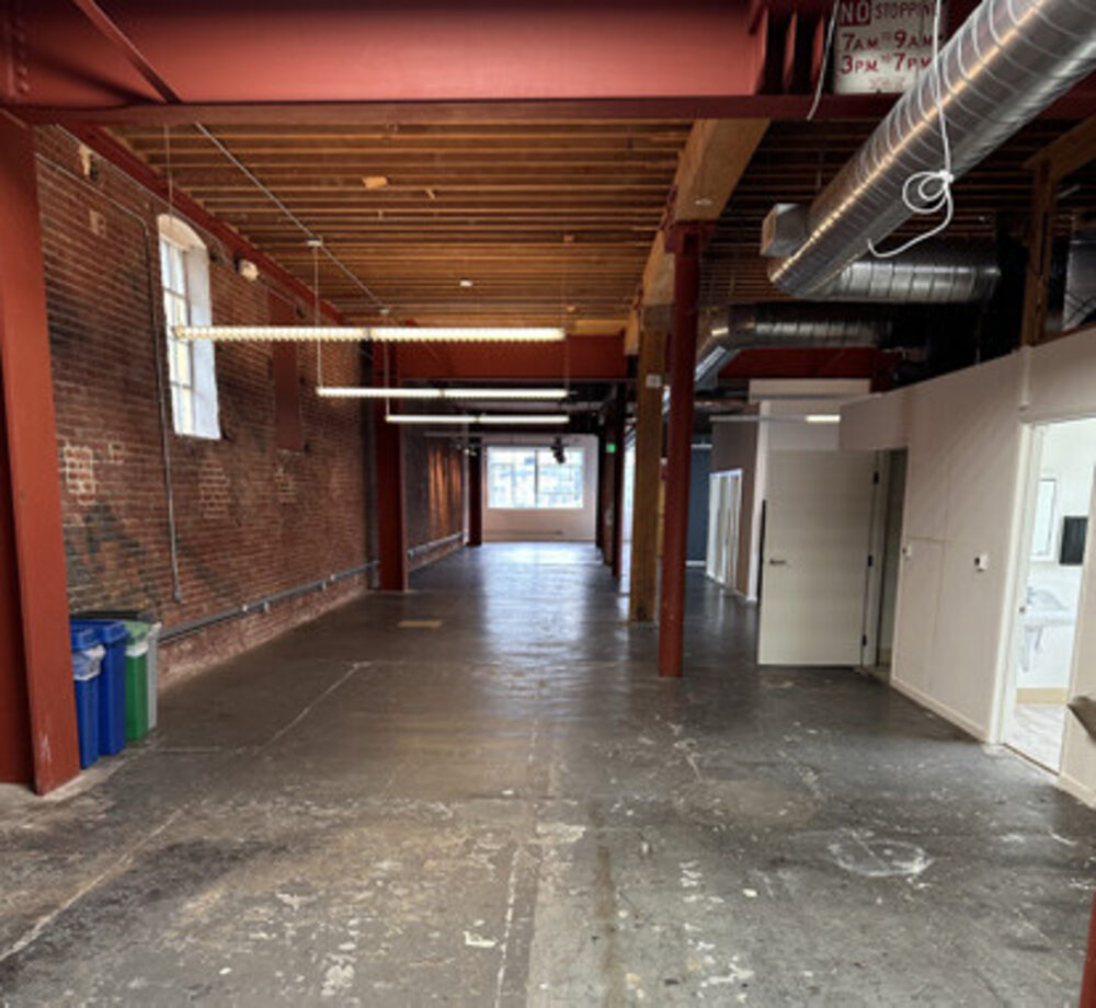 1261-1263 Howard Street open floor with exposed timber ceiling